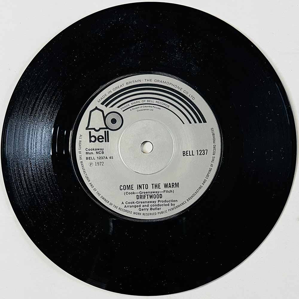 Driftwood Käytetty 7” ei kuvakantta Come Into The Warm  kansi Ei kuvakantta levy VG+ käytetty vinyylisingle