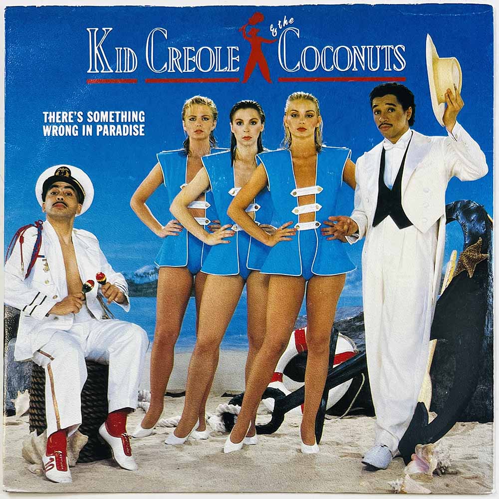 Kid Creole And The Coconuts vinyylisingle There's something wrong in paradise / Fireside Story  kansi EX- levy EX käytetty vinyy